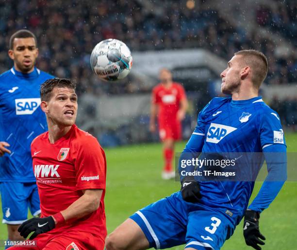 Florian Niederlechner of FC Augsburg and Pavel Kaderabek of TSG 1899 Hoffenheim batte for the ball during the Bundesliga match between TSG 1899...