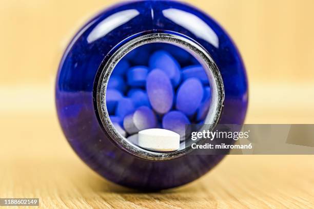 spilled capsules from prescription bottle. medical concept - viagra bildbanksfoton och bilder