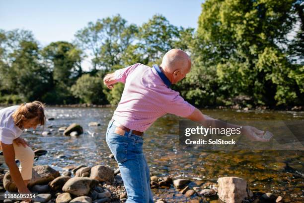 skipping stones together - skimming stones stock pictures, royalty-free photos & images