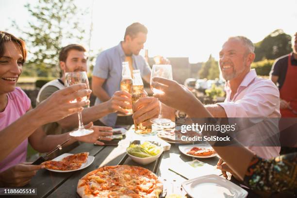 toasting to friendship - al fresco dining stock pictures, royalty-free photos & images