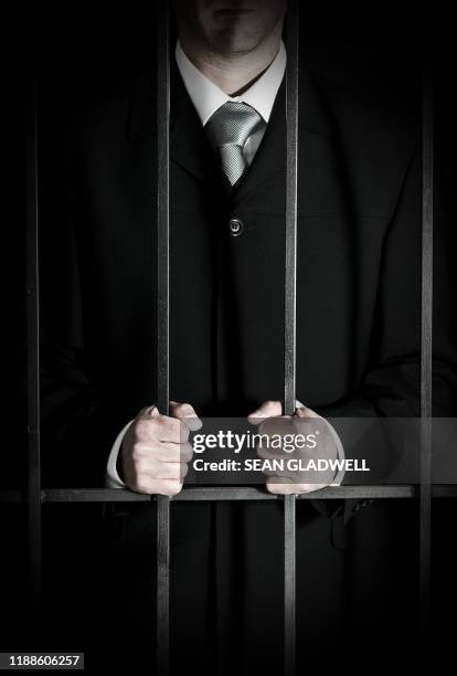 business man in prison - hands on prison bars stock pictures, royalty-free photos & images