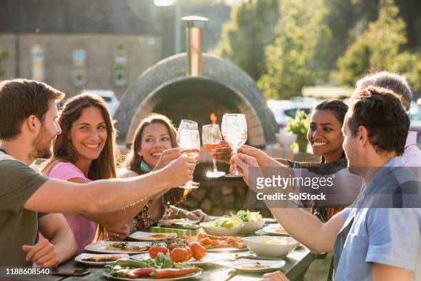 friends celebrating together - al fresco dining stock pictures, royalty-free photos & images