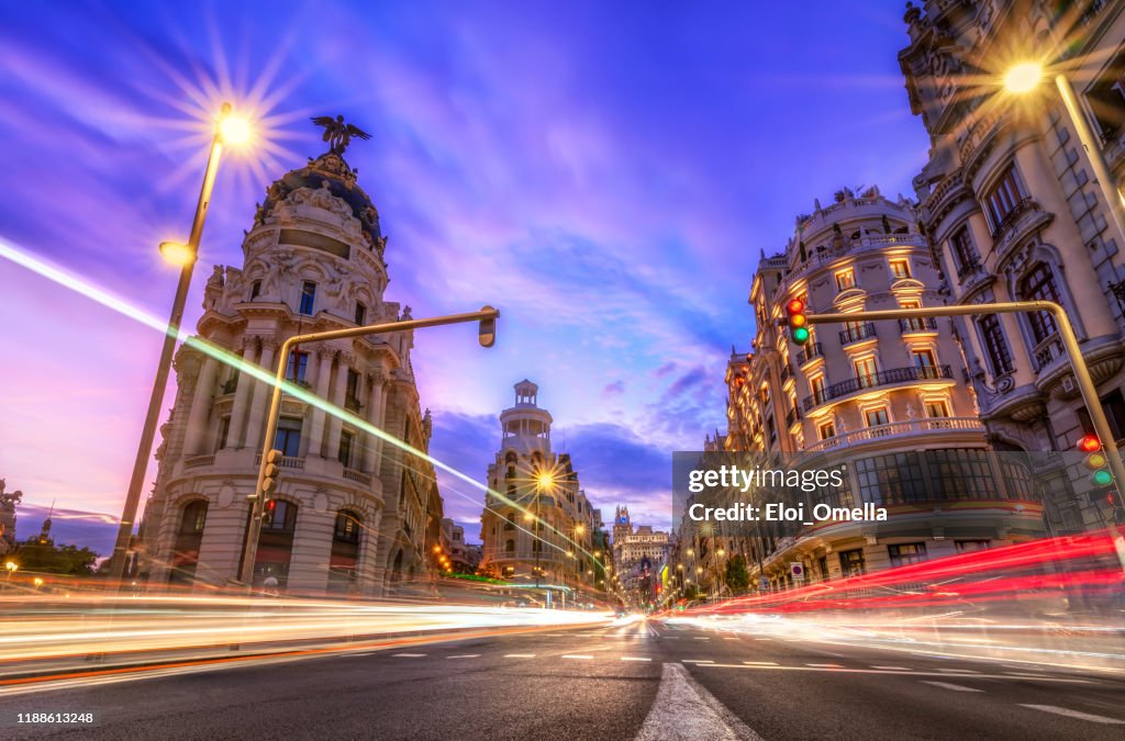 Gran via in Madrid at sunset with car light trails. Spain