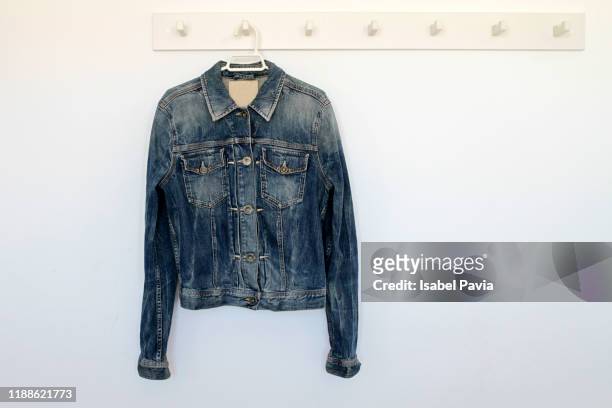 denim jacket hanging on rack - jacket stock pictures, royalty-free photos & images
