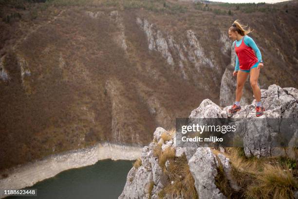 young woman running on mountain - high up stock pictures, royalty-free photos & images