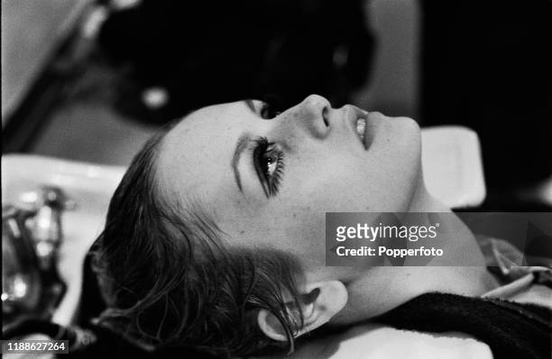 English model Twiggy has her hair washed in a sink at a hair salon in London in October 1966.