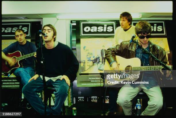 British rock band Oasis performing live at an in-store promotion gig, UK, 1994; they are Paul Arthurs, Liam Gallagher, Noel Gallagher and Evan Dando...
