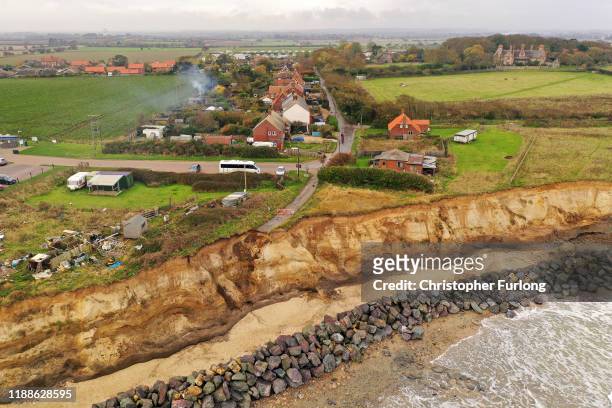 The end of a tarmac road shows the devastation caused by coastal erosion of the cliff face in the village of Happisburgh on November 06, 2019 in...