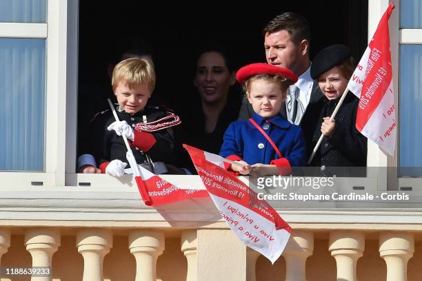 Prince Jacques of Monaco and Princess Gabriella of Monaco and Kaia-Rose Wittstock pose at the Palace balcony during the Monaco National Day...