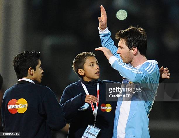 Argentine forward Lionel Messi greets children at the end of the 2011 Copa America Group A first round football match against Costa Rica, at the...