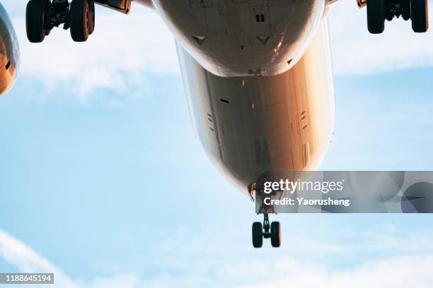 a landing airplane approach the airport - landing gear stock-fotos und bilder