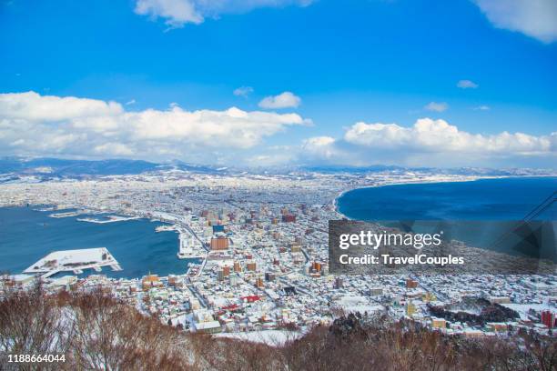 beautiful landscape and cityscape from mountain hakodate for look around city skyline building and architecture with blue sky white cloud. hakodate, hokkaido, japan city skyline from mt. hakodate at dusk in autumn season. - hokkaido stockfoto's en -beelden