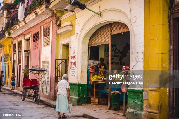 everyday life in the street of havana in cuba with people going about their way in a colorful and vibrant organized chaos with a vintage and traditional vibe - cuban ethnicity stock pictures, royalty-free photos & images