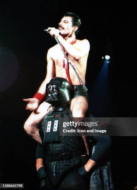 British singer, songwriter and lead vocalist of the rock band Queen, Freddie Mercury, sits on the shoulders of Darth Vader as they perform their...