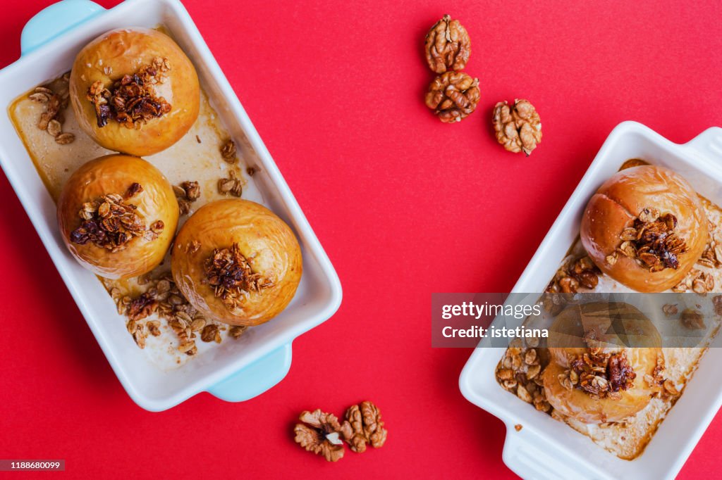 Sweet vegan dessert, baked apples on red background