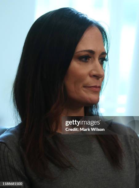 White House press secretary Stephanie Grisham listens to U.S. President Donald Trump speak to the media during a cabinet meeting at the White House...