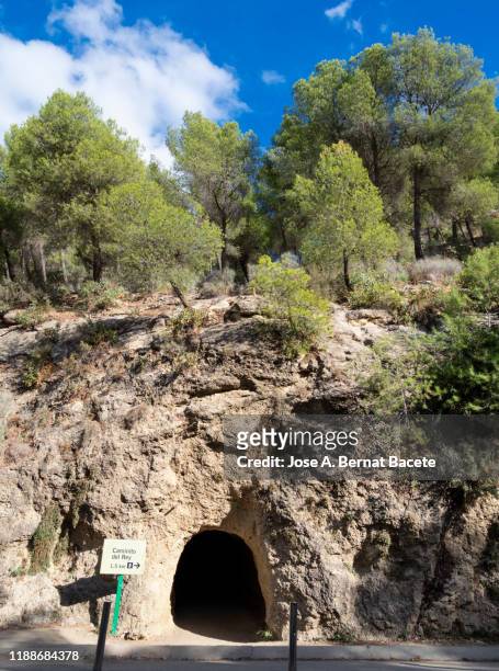 sign trail, entrance to a tunnel in the field. - caminito del rey málaga province stock pictures, royalty-free photos & images