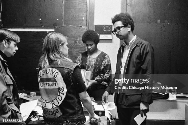 American social activist and Illinois Black Panther Party chapter founder Bobby Rush talks with an unidentified member of the Young Patriots...