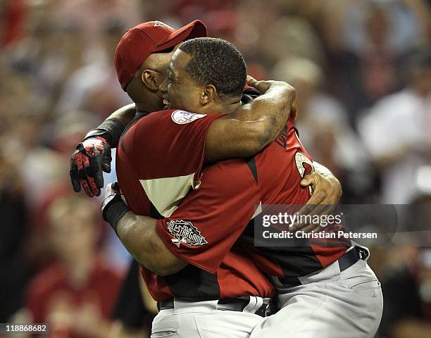 American League All-Star Robinson Cano of the New York Yankees hugs his father Jose after winning the 2011 State Farm Home Run Derby at Chase Field...
