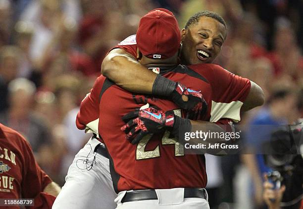 American League All-Star Robinson Cano of the New York Yankees hugs his father Jose after winning the 2011 State Farm Home Run Derby at Chase Field...
