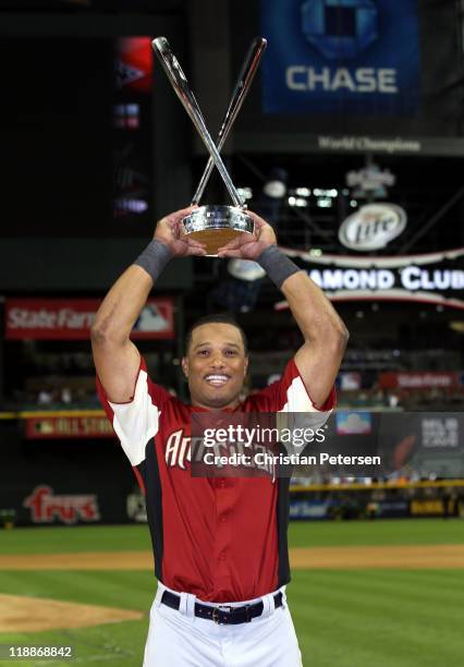 American League All-Star Robinson Cano of the New York Yankees celebrates with the trophy after winning the 2011 State Farm Home Run Derby at Chase...