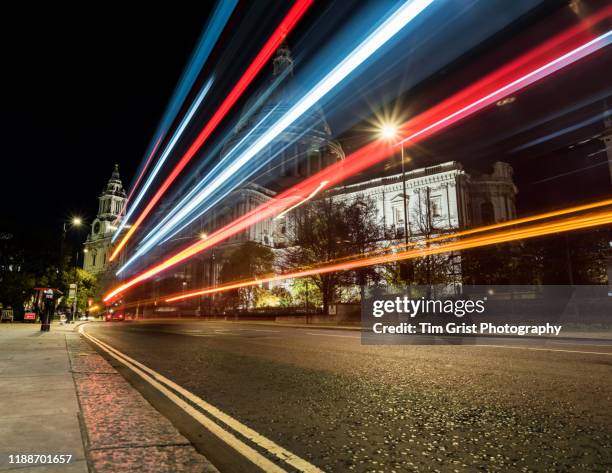 traffic light trails on a city street at night in front of st paul's cathedral, london. uk - car lights stock pictures, royalty-free photos & images