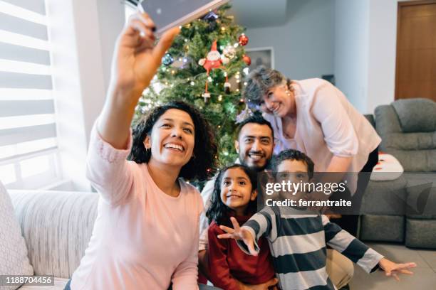 family selfie by christmas tree - mexican christmas stock pictures, royalty-free photos & images