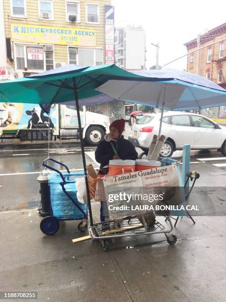 Guadalupe Galicia from Mexico, sells her tamales and arroz con leche on the corner of Knickerbocker Ave. And Dekalb Ave. In the Brooklyn Borough of...