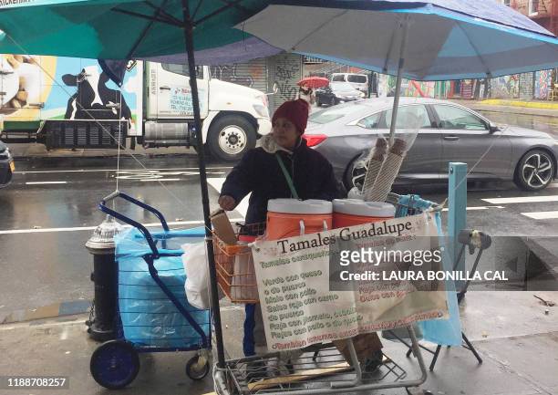 Guadalupe Galicia from Mexico, sells her tamales and arroz con leche on the corner of Knickerbocker Ave. And Dekalb Ave. In the Brooklyn Borough of...