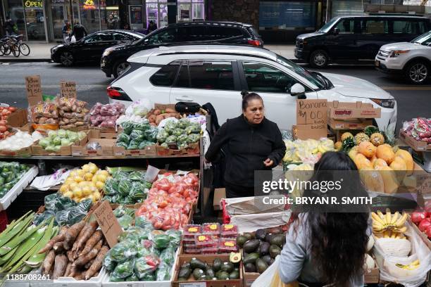 Sabina Morales Hernandez sells produce at her street stand on Junction Blvd. In the Queens Borough of New York City on November 27, 2019. - Street...