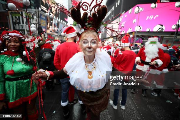 People dress up as Santa Claus on SantaCon day at Times Square in New York, United States on December 14, 2019. Santacon began in San Francisco in...