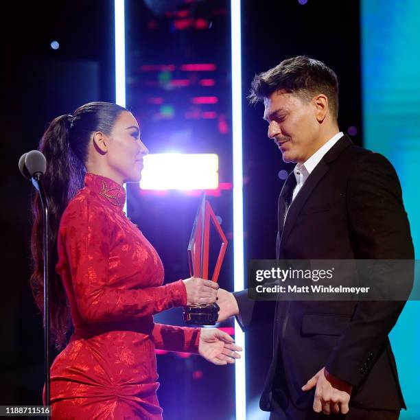 Kim Kardashian presents Mario Dedivanovic with award onstage during the 2nd Annual American Influencer Awards at Dolby Theatre on November 18, 2019...