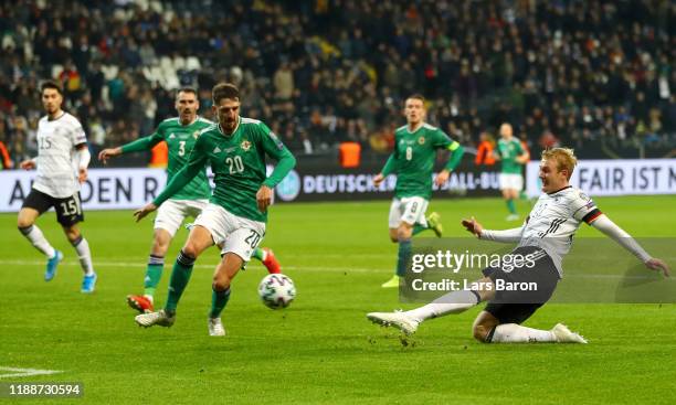 Julian Brandt of Germany scores his team's sixth goal as Craig Cathcart of Northern Ireland reacts during the UEFA Euro 2020 Qualifier between...