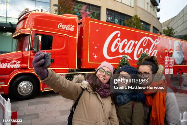 Three women take a selfie in front of the Coca Cola truck in Cardiff city centre on November 16, 2019 in Cardiff, United Kingdom.