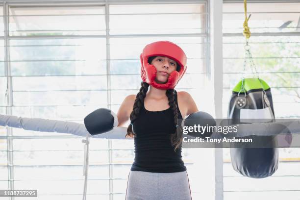 teenage girl in boxing gym with boxing gloves and head gear - boxing ring stock pictures, royalty-free photos & images