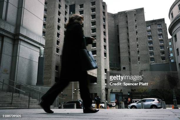 Woman walks by the Metropolitan Correctional Center, which is operated by the Federal Bureau of Prisons, stands in lower Manhattan on November 19,...