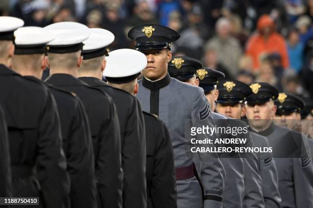 Army and Navy members meet half way as US President Donald Trump attends the Army-Navy football game in Philadelphia, Pennsylvania on December 14,...
