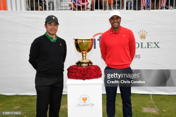 International Team's Hideki Matsuyama of Japan and U.S. Team's Tony Finau pose with the trophy on to the first tee during the final round singles...