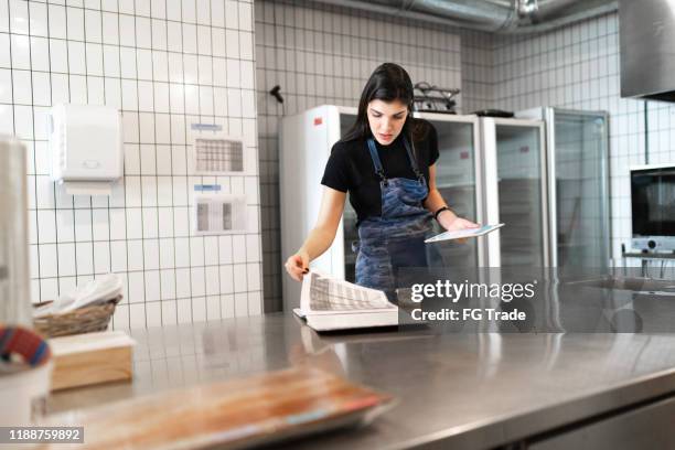 female business owner checking kitchen supplies - restaurant inspection stock pictures, royalty-free photos & images