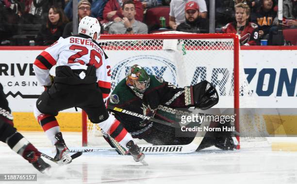 Goalie Darcy Kuemper of the Arizona Coyotes stops the puck on the shot attempt by Damon Severson of the New Jersey Devils during the third period of...