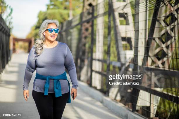 mexican woman walking - fat people stock pictures, royalty-free photos & images