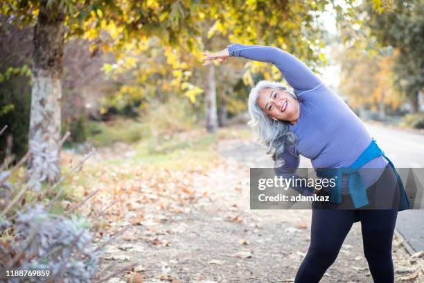 mexican woman stretching back - stretching hamstring stock pictures, royalty-free photos & images