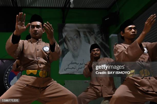 This picture taken on December 14, 2019 shows pencak silat practitioners, a martial art indigenous to Southeast Asia, practice in Jakarta. - The...