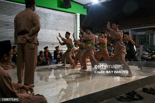 This picture taken on December 14, 2019 shows pencak silat practitioners, a martial art indigenous to Southeast Asia, taking part in a session in...