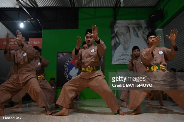 This picture taken on December 14, 2019 shows pencak silat practitioners, a martial art indigenous to Southeast Asia, taking part in a session in...