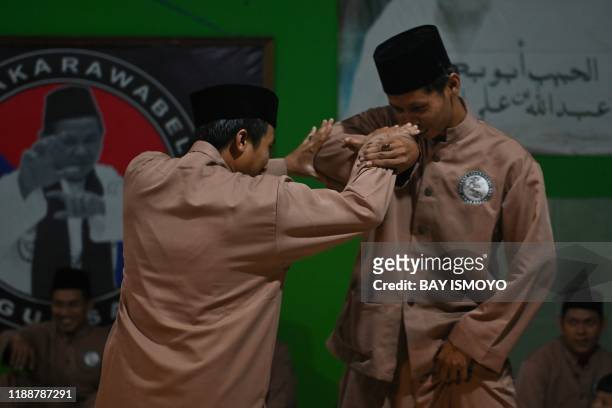 This picture taken on December 14, 2019 shows pencak silat practitioners, a martial art indigenous to Southeast Asia, sparring during practice in...