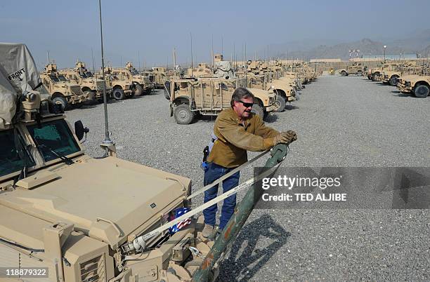 Hal Moore from AC first company, a private contracting company tasked in repairing weapons and vehicles used by US soldiers in Afghanistan, inspects...