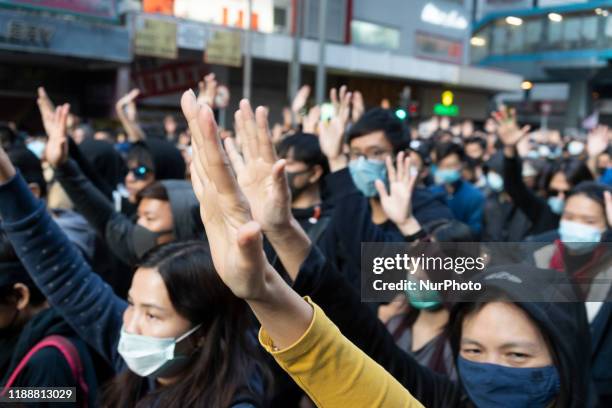 Pro-democracy protesters march on a street as they take part in a demonstration on December 8, 2019 in Hong Kong, China.
