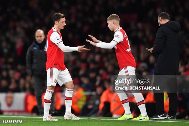 Arsenal's German midfielder Mesut Ozil is substituted for Arsenal's English midfielder Emile Smith Rowe during the English Premier League football...