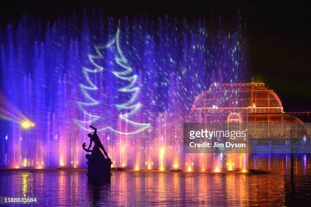 The Palm House at Kew Gardens is illuminated with a light show during a preview for the Christmas at Kew event on November 19, 2019 in London,...